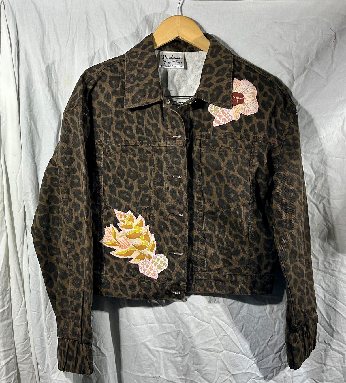Leopard, leis, shells, and ‘Iwa bird Jacket